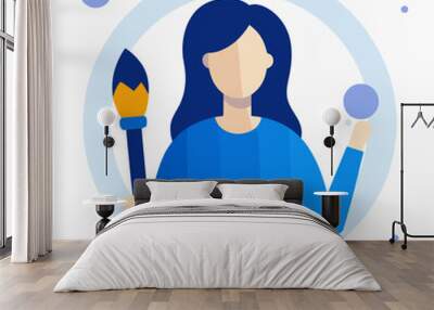 A woman holding a paintbrush in a blue shirt. Concept of creativity and artistic expression Wall mural