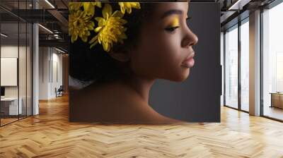 Young african american woman with artistic make-up and flowers in hair on grey background. Wall mural