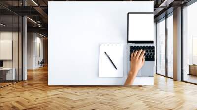 Copy space, laptop with white blank screen, mockup for announcement, advertising. Top view, female hands lie on a laptop keyboard with a blank white screen, typing text, browsing Internet Wall mural