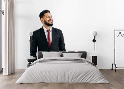 Copy-space for your presentation. Friendly elegant influential arabian or indian man in formal suit, standing over isolated white background, looking away, thinking, planning, dreaming, smiles happily Wall mural