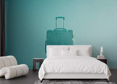 Blue suitcase on pastel blue background, travel concept  Wall mural