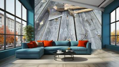 two axes, hammer and nails lie on wooden boards Wall mural