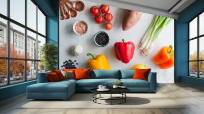 Overhead flat lay of dinner meal prep with fresh healthy vegetables on a white background Wall mural