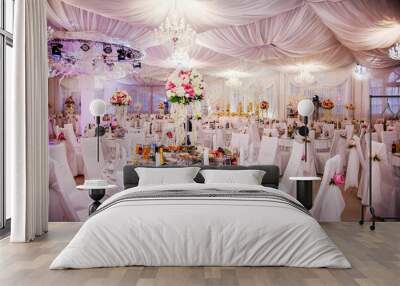 The table at the wedding banquet, served and decorated with floral arrangements Wall mural