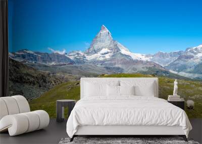 Flock of Valais blacknose sheep grazing in Zermatt, Switzerland with the Matterhorn in the background Wall mural