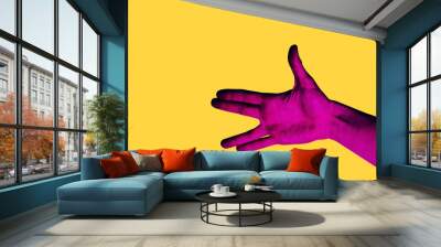 Isolated hand photo on yellow background. Pink hand collage style. Bright pop art template with space for text. Creative minimalistic backdrop. Poster, banner idea. Gestures with fingers Wall mural