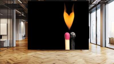 Flaming heart over two matchsticks on black Wall mural