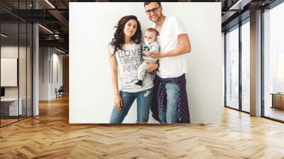 Hipster father, mother holding cute baby boy over white backgrou Wall mural