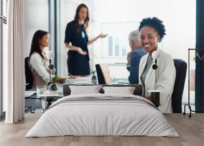 Happy assistant or intern looking cheerful in a team planning meeting at work. Portrait of a proud employee with colleagues as they discuss new innovative plans and strategy in a corporate office Wall mural