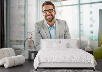 Its been a successful workday. Portrait of a handsome young businessman sitting in an office. Wall mural