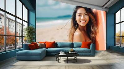 Asian female surfer on the beach with surfboard in hand. Beautiful female surfer smiling at camera, ready to go surfing. Summer at the beach, surfing Wall mural