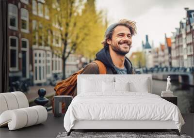 Man traveling in Amsterdam. Happy young traveler exploring in city. Wall mural