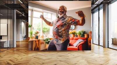 Positive black older man dancing at home. Happiness and well being concept. Wall mural