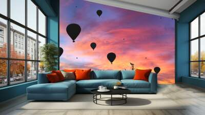 Black silhouettes of the hot air baloons over the circus tent on colorful sunset background Wall mural