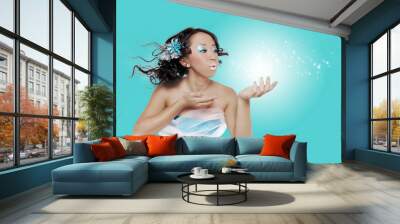 Woman With Frosty Make Up Blowing Sparkles Wall mural