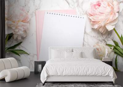 Beautiful white peony flower and notebook on marble background Wall mural