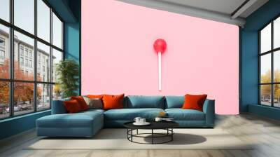 Sweet pink candy lolipop on pastel pink background.Minimalist composition. Wall mural