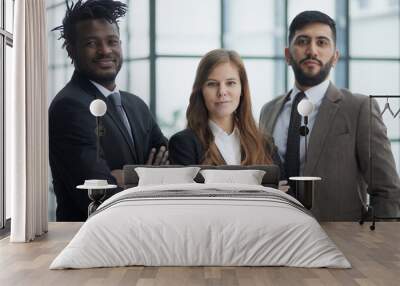 a group of three employees posing together with their arms crossed Wall mural