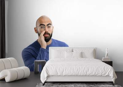 A man, on a white background, in close-up, tells a secret Wall mural