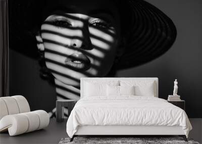 Black and white portrait of a woman in a hat with shadows on her face Wall mural