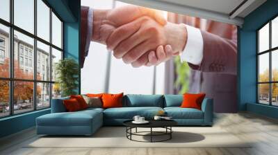 Building a strong business network. two businessmen shaking hands in a modern office. Wall mural