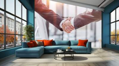 Building a strong business network. two businessmen shaking hands in a modern office. Wall mural