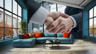 Business partners shaking hands in meeting hall Wall mural