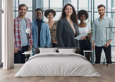 business woman with her staff in background at office Wall mural