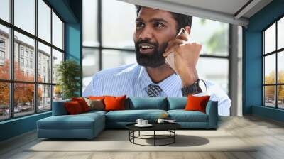 businessman talking on phone with customers, male salesman working inside modern office building. Wall mural