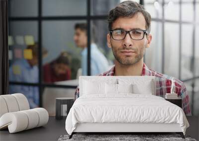 Closeup shot of cheerful young man in eyeglasses. Wall mural