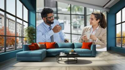 colleagues talking during lunch break while sitting at workplace Wall mural