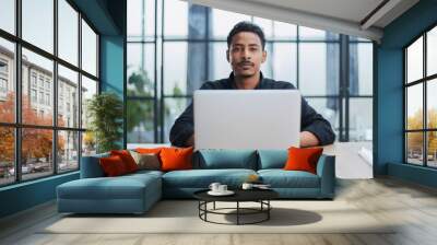 Creative Businessman Working at Desk with Laptop in Modern Office Wall mural