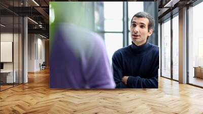 Diverse friendly male colleagues talking while walking Wall mural