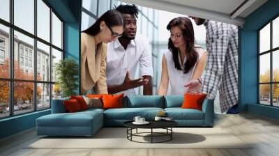 Group of coworkers in discussion in office Wall mural