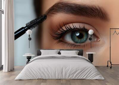 Makeup artist applying mascara on eyelashes of young woman, closeup Wall mural