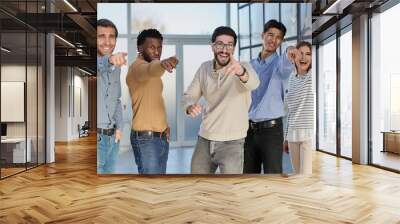 Portrait of excited young business pointing at you Wall mural