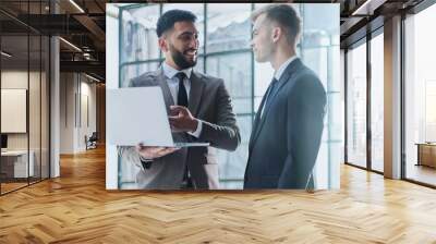 two professional businessmen discussing and using desktop computer in office Wall mural