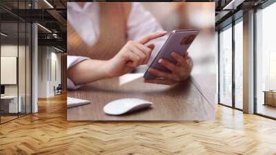 young woman in modern office browsing smartphone Wall mural