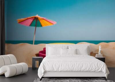 pink and yellow podium on sandy beach with ocean in background Wall mural