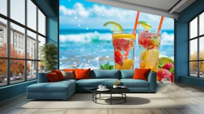 two glasses with a summer refreshing drink, lemonade with ice on the sea background Wall mural