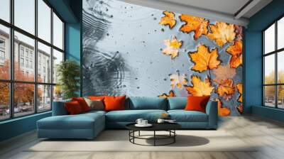 Bright orange maple leaves floating on water, creating a vibrant autumn scene. Wall mural