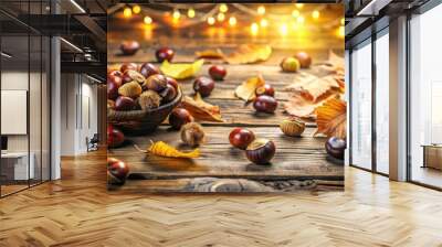 Chestnuts scattered on a rustic wooden table surrounded by autumn leaves and warm string lights. Wall mural