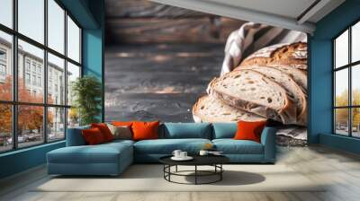 Thick slices of freshly baked country bread on a rustic wooden table. Wall mural