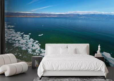 Lake Baikal at spring time. Top view on the coast of the Olkhon Island and the Small Sea Strait with white ice floes on blue water. Nature background. Beautiful spring landscape Wall mural