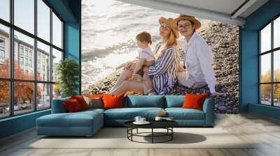 Family by the sea at sunset Wall mural