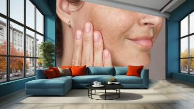 Cropped photo of caucasian woman's face with freckles or age spots photo. She loves her skin close up Wall mural