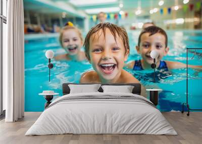 Diverse young children enjoying swimming lessons in pool, learning water safety skills, showing joy and camaraderie, representing a healthy lifestyle. Wall mural