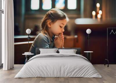 Little girl praying to god in church. Faith in religion and belief in God. Power of hope or love and devotion. Wall mural