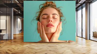 Young woman doing face building, facial gymnastics, self massage and rejuvenating exercises Wall mural