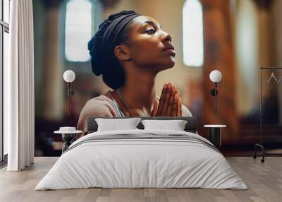 Young woman praying to god in church. Faith in religion and belief in God. Power of hope or love and devotion. Wall mural